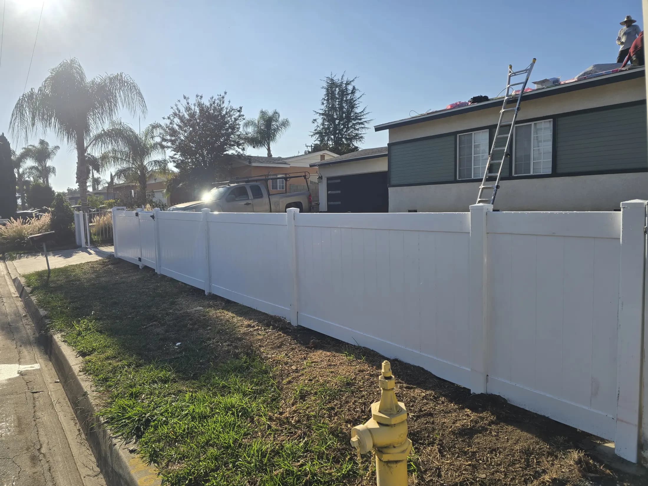 White vinyl front yard fence along a residential street